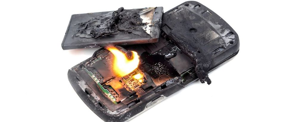 An unidentified mobile phone battery explodes and burns due to overheating. [Shutterstock - wk1003mike - 327590033]
