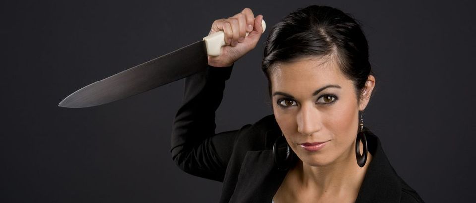 Woman holding knife (Shutterstock)