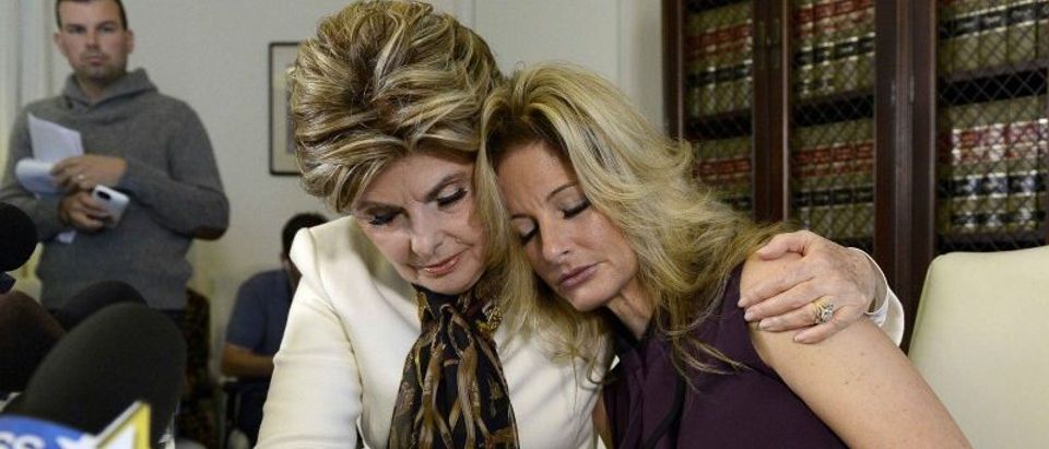 Summer Zervos is embraced while speaking to reporters about allegations of sexual misconduct against Donald Trump during a news conference in Los Angeles