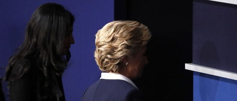 Democratic U.S. presidential nominee Clinton walks offstage with aide Abedin after the conclusion of her debate against Republican U.S. presidential nominee Trump in St. Louis