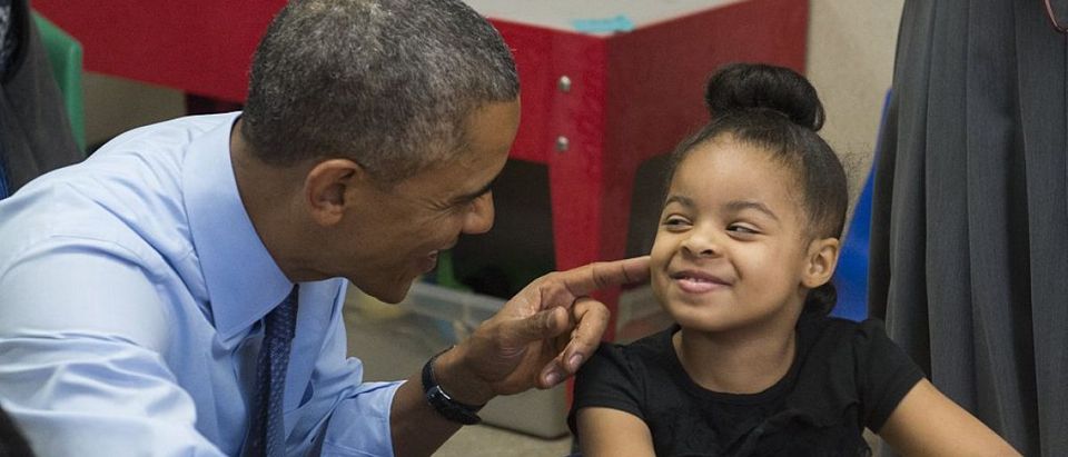 US President Barack Obama talks with Akira Cooper during a visit to a classroom at the Community Children's Center, one of the country's oldest Head Start providers. Saul Loeb/AFP/Getty Images