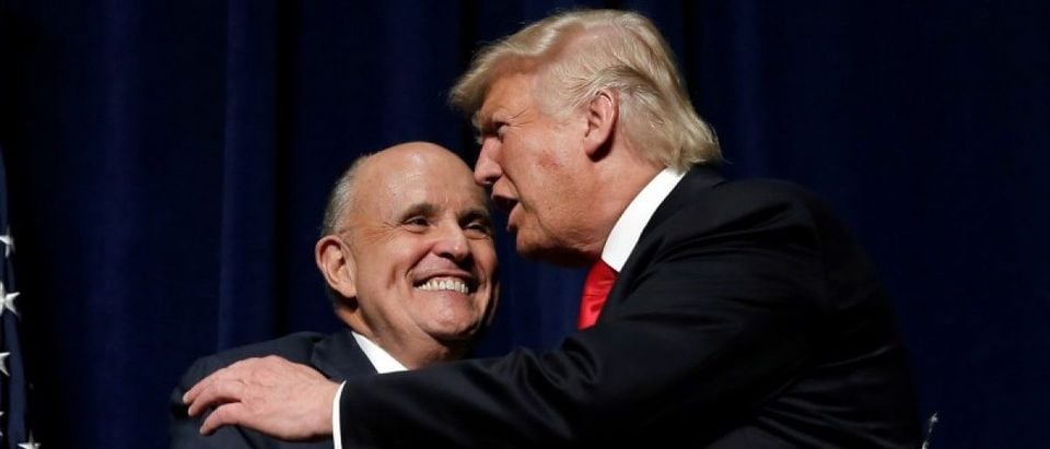 Republican presidential nominee Donald Trump embraces former New York City Mayor Rudolf Giuliani at a campaign rally in Greenville