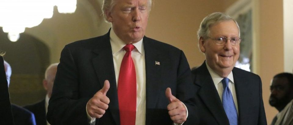 U.S. President-elect Donald Trump gives a thumbs up sign as he walks with Senate Majority Leader McConnell on Capitol Hill in Washington