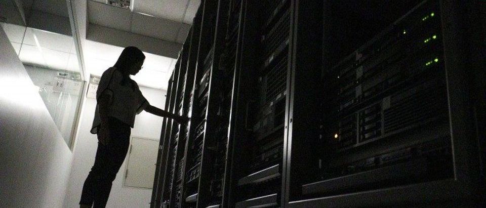 An employee works inside a server room at a company in Bangkok