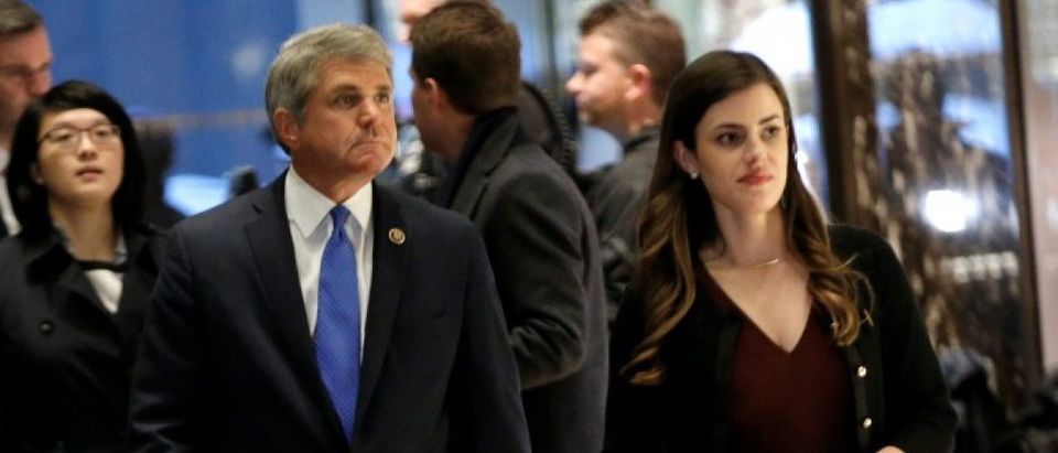 U.S. Representative Michael McCaul (R-TX) is escorted by Madeleine Westerhout as he arrives at Trump Tower to meet with U.S. President-elect Donald Trump