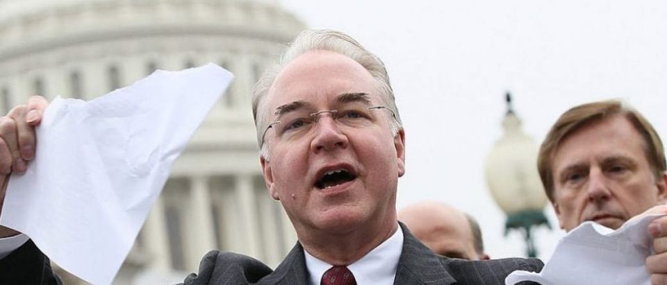 Tom Price tears a page from the national health care bill during a press conference at the U.S. Capitol on March 21, 2012 (Getty Images)