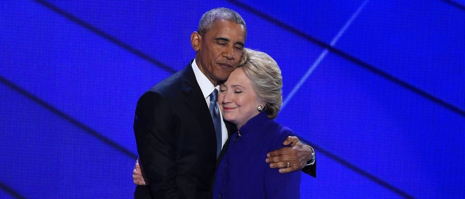 Obama and Clinton embrace on stage during the Democratic National Convention. SAUL LOEB/AFP/Getty Images