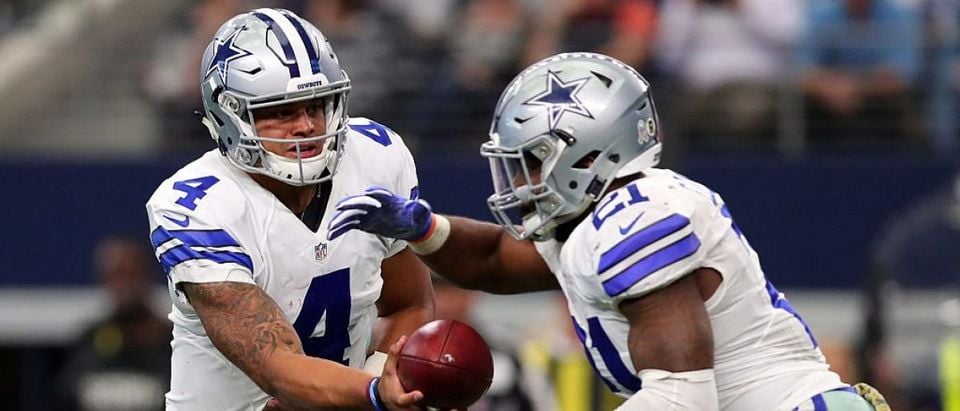 Dak Prescott #4 hands off to Ezekiel Elliott #21 of the Dallas Cowboys during the second half against the Baltimore Ravens at AT&T Stadium on November 20, 2016 in Arlington, Texas. (Photo by Tom Pennington/Getty Images)