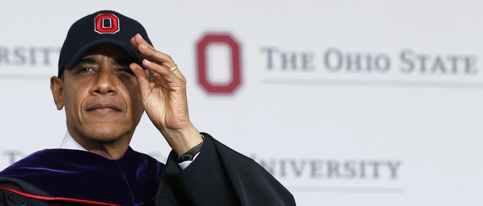 Barack Obama dons an Ohio State University cap (REUTERS/Jason Reed)