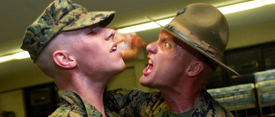 United States Marine Corps drill instructor yells at a recruit after wakeup