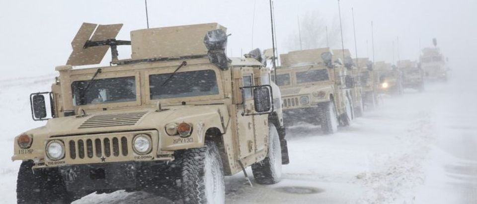 North Dakota National Guard vehicles are parked on Highway 1806 during a march against the Dakota Access Oil Pipeline north of Backwater Bridge and the Oceti Sakowin Camp