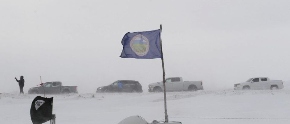 People line up in their cars as they leave Oceti Sakowin camp as "water protectors" continue to demonstrate against plans to pass the Dakota Access pipeline near the Standing Rock Indian Reservation, near Cannon Ball