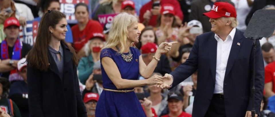 U.S. President-elect Donald Trump greets campaign manager and senior advisor, Kellyanne Conway (C), and Campaign Communications Director Hope Hicks (L) during a USA Thank You Tour event in Mobile, Alabama, U.S., December 17, 2016. REUTERS/Lucas Jackson