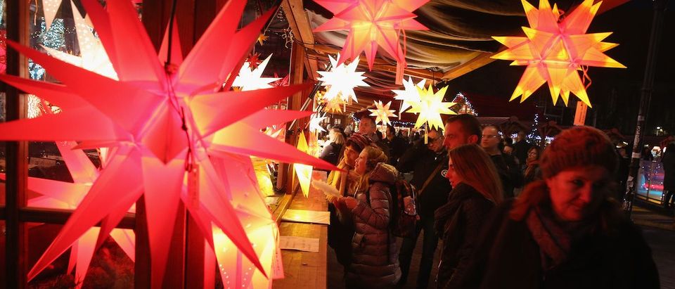 Visitors walk past a stall selling illuminated stars at the annual Christmas market at Alexanderplatz on November 24, 2015 in Berlin, Germany. Christmas markets are opening across Germany this week as Europe remains tense following the recent terror attacks in Paris and the continued manhunt for those involved. (Photo by Sean Gallup/Getty Images)