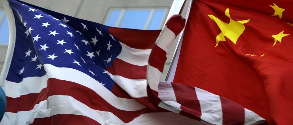 National flags of U.S. and China wave in front of an international hotel in Beijing