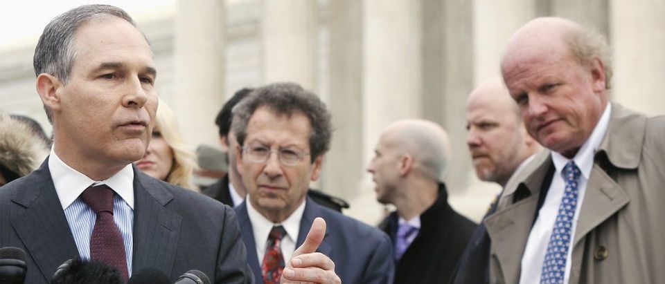 Attorney General of Oklahoma Scott Pruitt (L), a critic of the U.S. government in the King v. Burwell case, speaks to reporters after arguments at the Supreme Court building in Washington, March 4, 2015. Also pictured are plaintiffs' attorneys Sam Kazman (C) and Michael Carvin (R). The U.S. Supreme Court appeared divided on ideological lines on Wednesday as it heard a second major challenge to President Barack Obama's healthcare law targeting tax subsidies intended to help people afford insurance, with Justice Anthony Kennedy appearing to be the possible swing vote in a decision. REUTERS/Jonathan Ernst