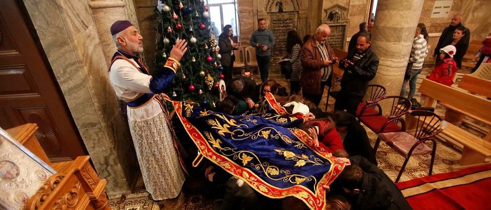 Iraqi Christians attend a mass on Christmas at an Orthodox church in the town of Bashiqa