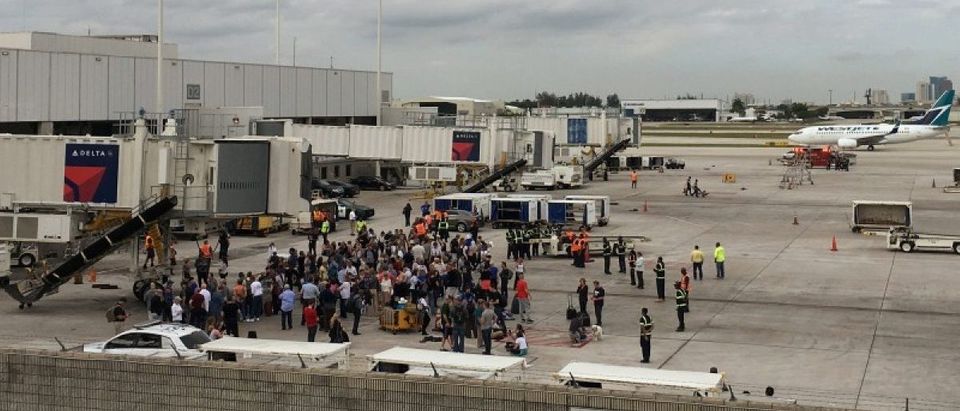 Travelers are evacuated out of the terminal and onto the tarmac after airport shooting at Fort Lauderdale-Hollywood International Airport in Florida
