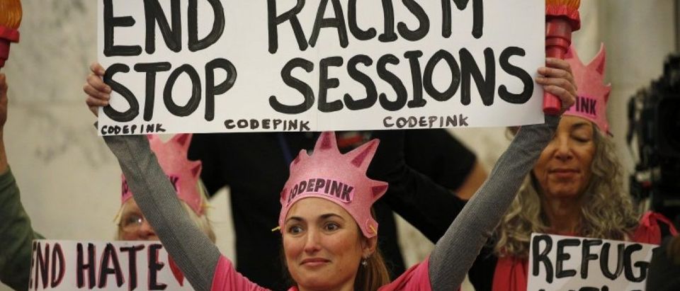 Protesters take positions at start of Senate Judiciary Committee confirmation hearing on Capitol Hill in Washington