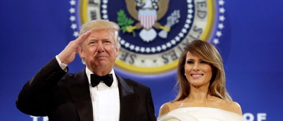 President Donald Trump salutes with his wife Melania