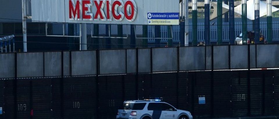 A U.S. border patrol vehicle drives along the border wall between Mexico and the United States in San Ysidro, California,