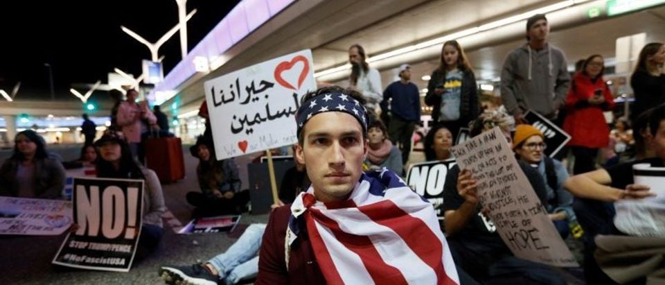 Demonstrators shut down the traffic loops at LAX International Airport and yell slogans during a protest against the travel ban imposed by U.S. President Donald Trump's executive order, at Los Angeles International Airport in Los Angeles