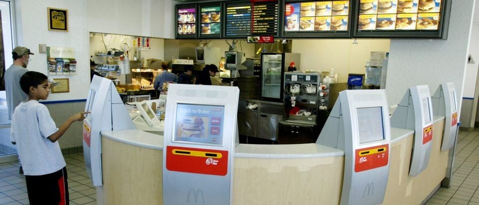 COMPUTER TERMINALS LINED UP ON COUNTER AT MCDONALDS.