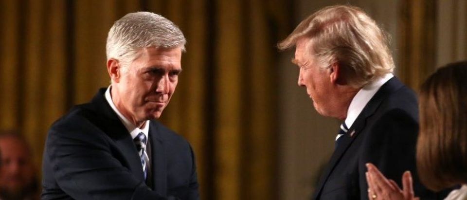 Judge Neil Gorsuch shakes hands with U.S. President Donald Trump as Gorsuch's wife Louise applauds after President Trump nominated Gorsuch to be an associate justice of the U.S. Supreme Court at the White House in Washington