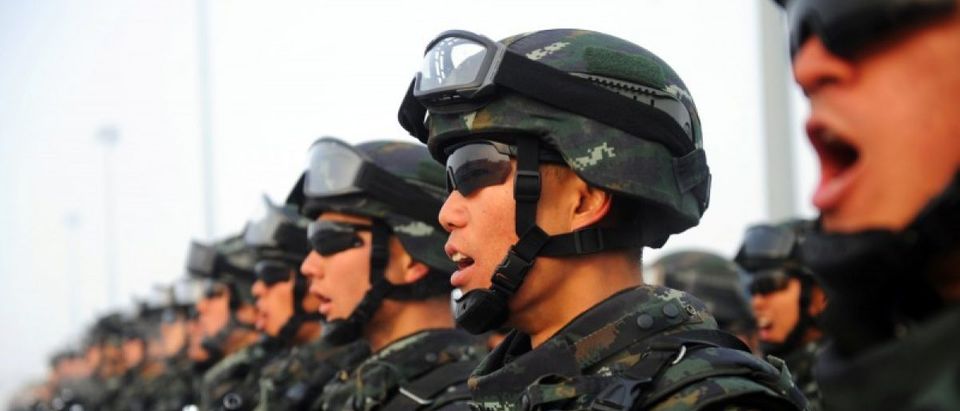 Paramilitary policemen stand in formation as they take part in an anti-terrorism oath-taking rally, in Kashgar