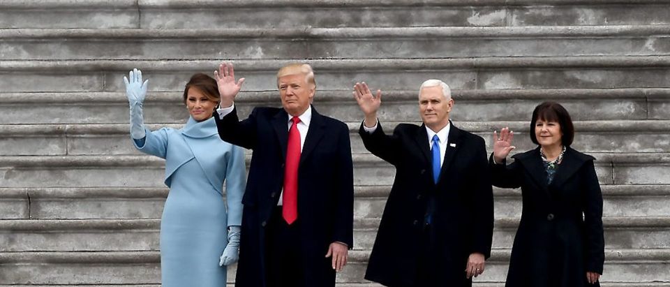 L-R: First Lady Melania Trump, US President Donald Trump, Vice President Mike Pence and his wife Karen, wave goodbye to former President Barack Obama's helicopter as it departs from the US Capitol after Trump's inauguration ceremonies at the US Capitol in Washington, DC, on January 20, 2017. (Photo credit: ROBYN BECK/AFP/Getty Images)