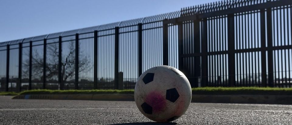 A soccer ball remains in a street in front of metal wall in the border between US and Mexico in Eagle Pass, US on February 21, 2017. Yuri Cortez/AFP/Getty Images.