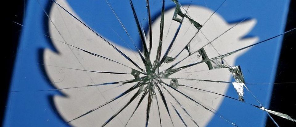 FILE PHOTO - A 3D-printed Twitter logo is seen through broken glass, in this picture illustration taken