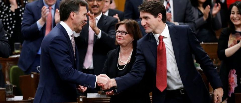 Canada's PM Trudeau shakes hands with Finance Minister Morneau in the House of Commons in Ottawa
