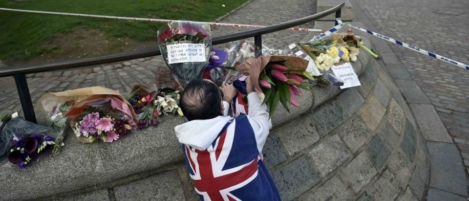 A man wears a Union Flag sweatshirt near the Houses of Parliament in Westminster the day after an attack, in London