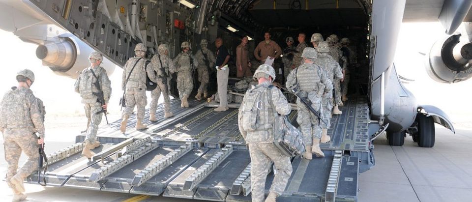 The flight crew of a C-17 oversees the boarding of soldiers from 3rd Infantry Division at Contingency Operating Base Speicher, Iraq, Aug. 23. These Dog Face soldiers are among the first to leave under the responsible drawdown of forces. (U.S. Army photo by Sgt. Ry Norris)