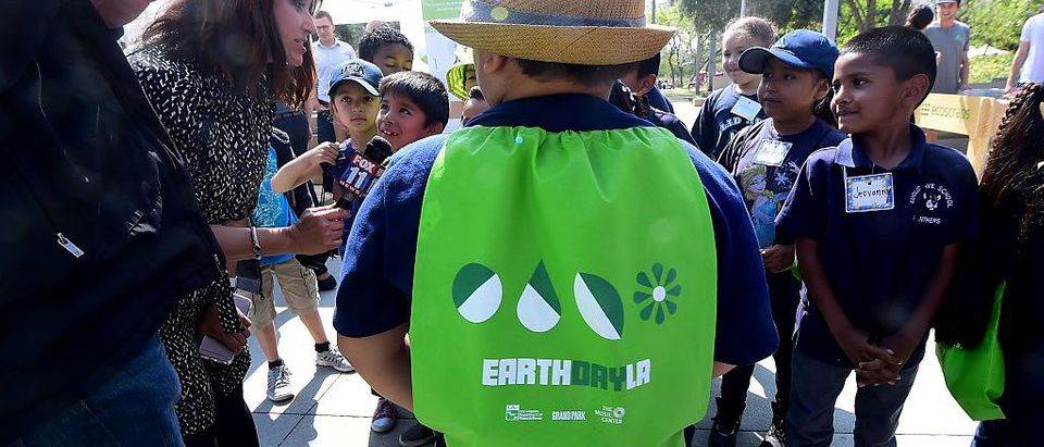 Children are interviewed by news media as elementary schoolchildren attend the Grand Park Earth Day celebration in downtown Los Angeles, California on April 22, 2016. Founded in 1970 as a day of education about environmental issues, Earth Day is now globally celebrated. FREDERIC J. BROWN/AFP/Getty Images