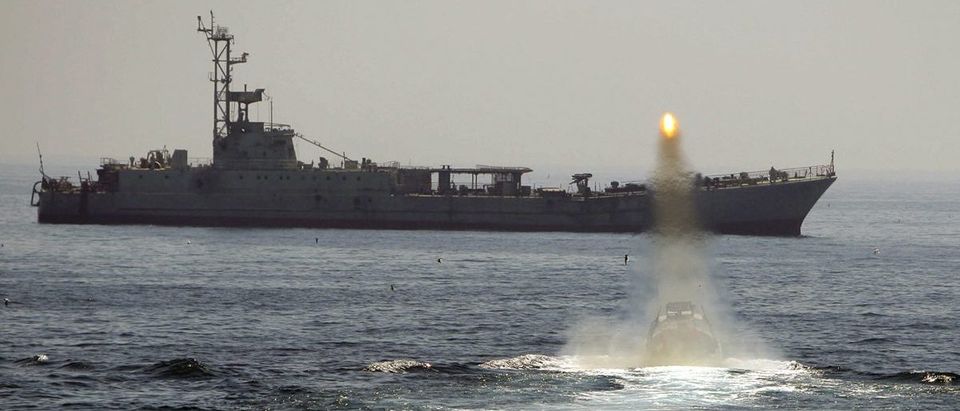 An Iranian warship and speed boats take part in a naval war game in the Persian Gulf and the Strait of Hormuz, southern Iran