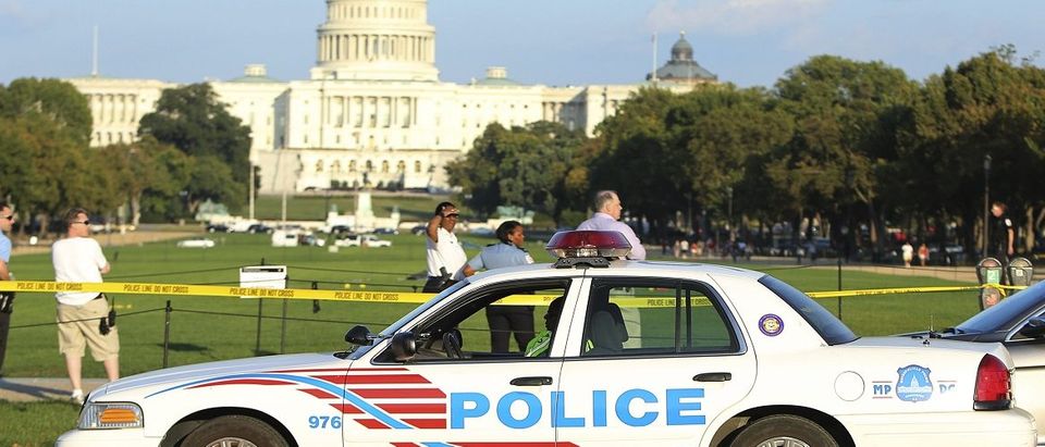 A Washington police car arrives at the scene where a man set himself on fire near the U.S. Capitol on the U.S. National Mall in Washington