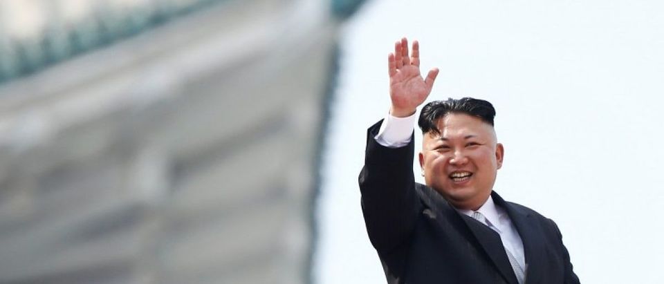 North Korean leader Kim Jong Un waves to people attending a military parade marking the 105th birth anniversary of country's founding father, Kim Il Sung in Pyongyang