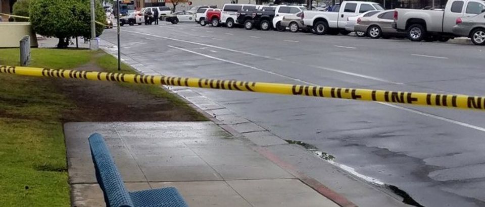 A road is blocked by police tape after a shooting incident in downtown Fresno
