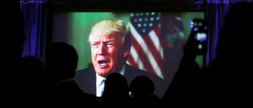 Guests watch a video of Trump as he addresses the 15th Plenary Assembly of the World Jewish Congress in New York