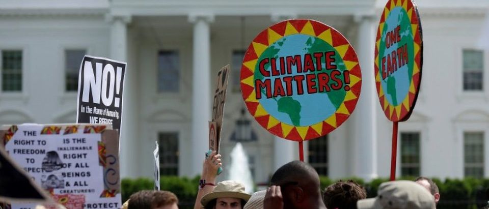 Protesters carry signs during the Peoples Climate March at the White House in Washington