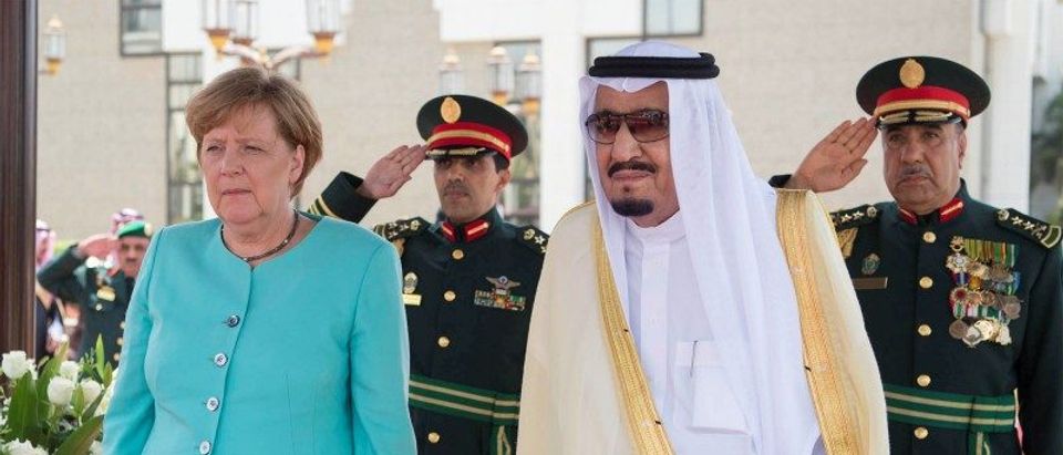 Saudi Arabia's King Salman bin Abdulaziz Al Saud stands next to German Chancellor Angela Merkel during a reception ceremony in Jeddah