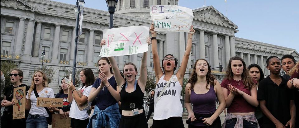 Students from Lick-Wilmerding High School, including Leah Atkins, 14, center left, and Annette Vergara, 15, center right, assemble in front of City Hall in protest of the election of Republican Donald Trump as President of the United States in San Francisco, California, U.S. November 10, 2016. (PHOTO: REUTERS/Elijah Nouvelage)
