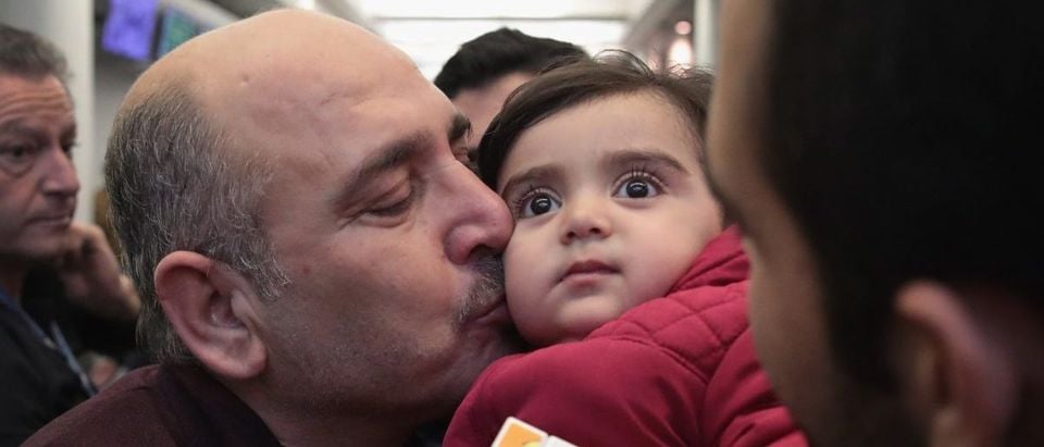 Khaled Haj Khalaf kisses his grandaughter Shams after she arrived with her mother and father at O'Hare Airport on a flight from Istanbul, Turkey on February 7, 2017 in Chicago, Illinois. (Scott Olson/Getty Images)