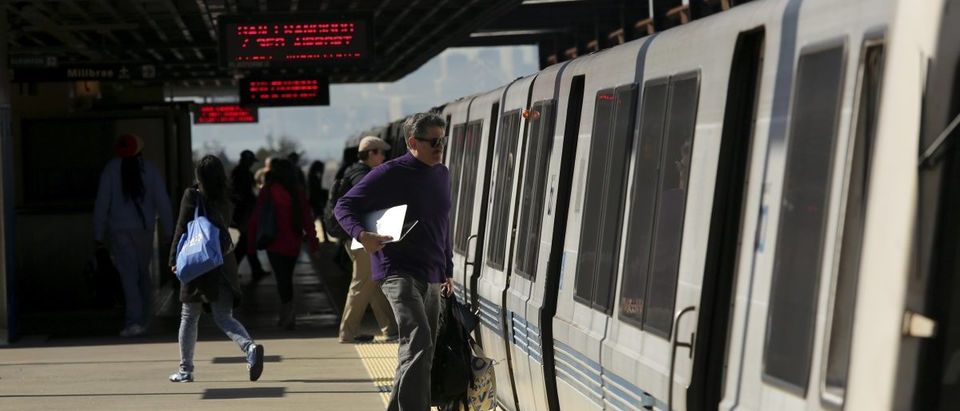 Passengers board a Bay Area Rapid Transit (BART) train at the Rockridge station in Oakland