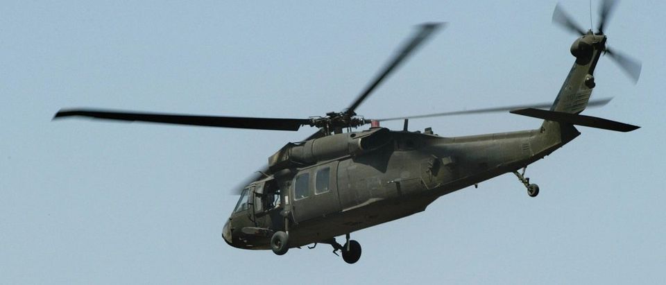 A US Army Black Hawk helicopter flies ov