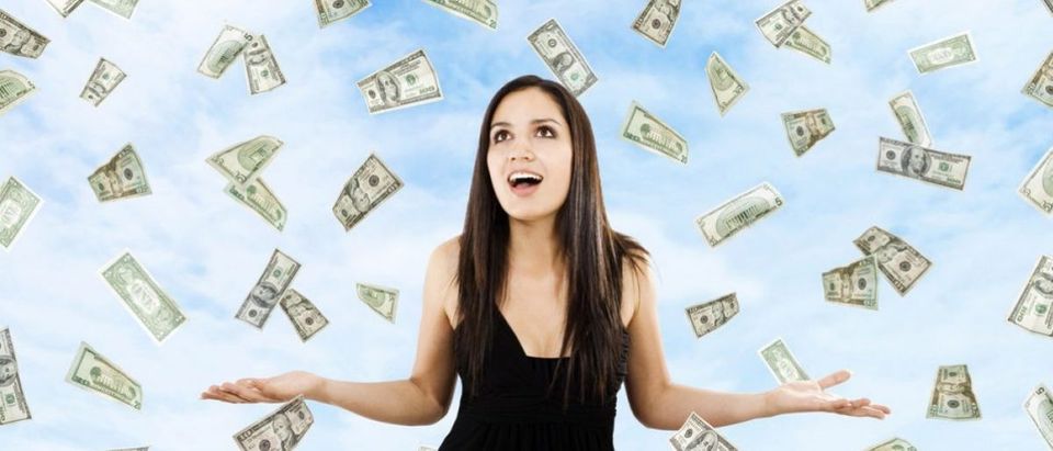 Woman is showered with money (Shutterstock/iodrakon)