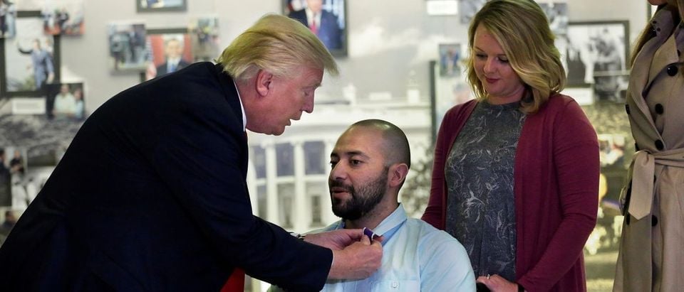 President Donald Trump awards a Purple Heart to Army Sgt First Class Alvaro Barrientos