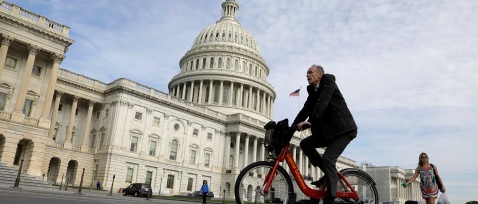 Cyclist passes the U.S. Capitol in Washington